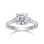 CARISSIE round moissanite solitaire ring, front view highlighting brilliant center stone and symmetrical side accents in polished metal