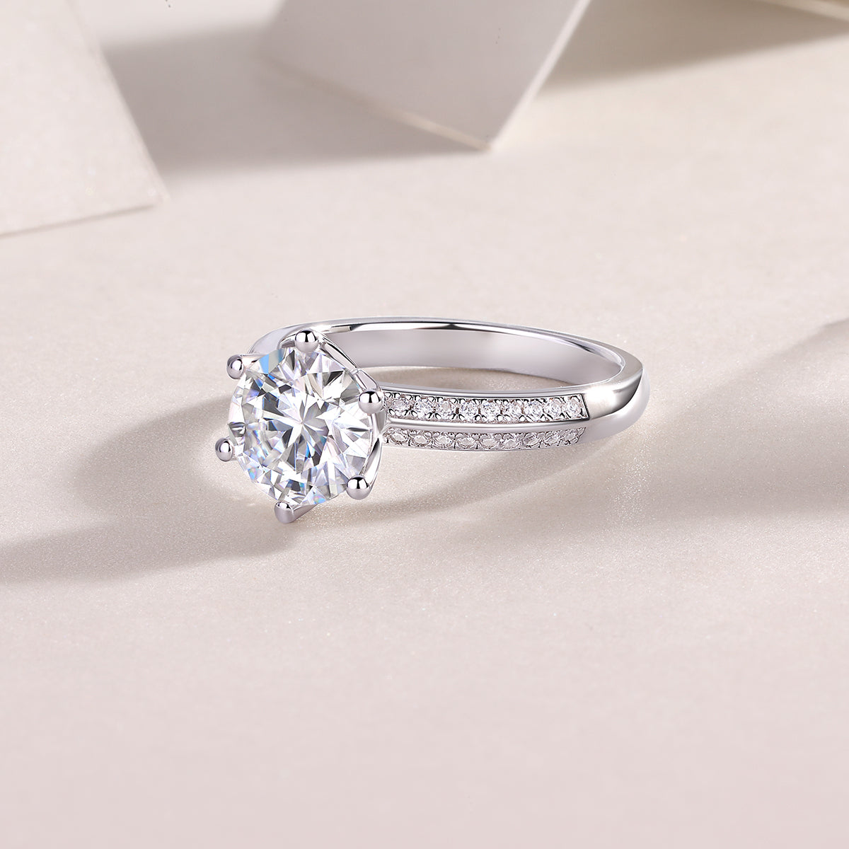 CARISSIE round moissanite solitaire ring, diagonal angle capturing the smooth polished metal finish and sparkling details