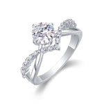 CARISSIE round moissanite solitaire ring, angled view showing twisted band with pavé accents and brilliant center stone