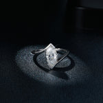 CARISSIE tension setting ring, front view against dark backdrop showing how the band grips the stone tips