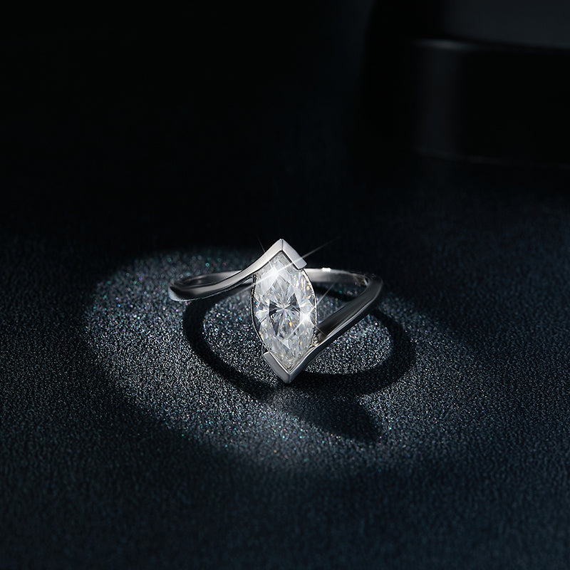 CARISSIE tension setting ring, front view against dark backdrop showing how the band grips the stone tips