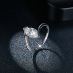 CARISSIE moissanite solitaire ring, side profile on glittery black background emphasizing the sleek modern silhouette