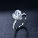 CARISSIE heart solitaire engagement ring, side profile highlighting the height of the stone and diamond accents