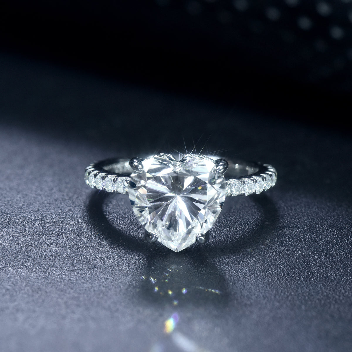 CARISSIE heart solitaire engagement ring, front view capturing fire and brilliance of the large moissanite center