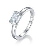 CARISSIE cushion moissanite bezel ring, angled view showing smooth silver-tone band and hidden inner accent stone