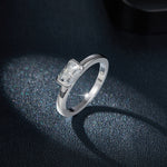CARISSIE cushion moissanite bezel ring, dramatic close-up on glittering surface emphasizing fire and modern aesthetic