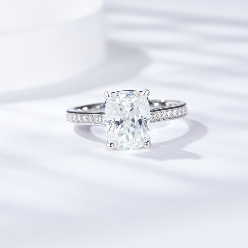 CARISSIE cushion solitaire engagement ring, front view highlighting the large moissanite stone and pavé split shank
