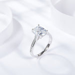 CARISSIE cushion solitaire engagement ring, angled perspective showing the curved shoulders and polished white metal band