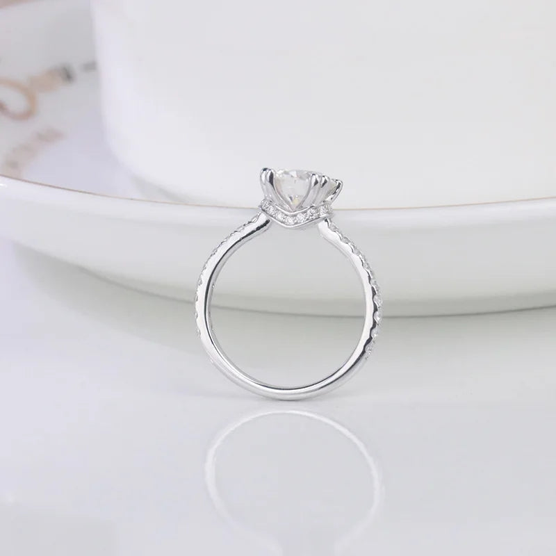 CARISSIE round moissanite solitaire ring, vertical angle displaying six-prong setting height and diamond accents