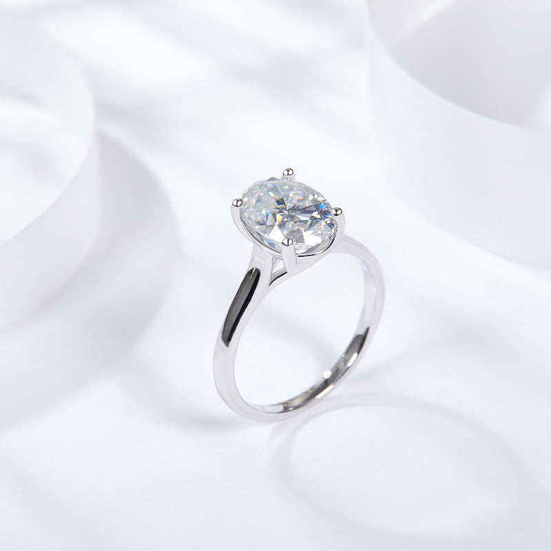CARISSIE oval moissanite solitaire ring, diagonal perspective highlighting the high-profile setting and tapered shank design