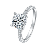 CARISSIE round moissanite solitaire ring, angled close-up highlighting brilliant center stone and pavé split shank band