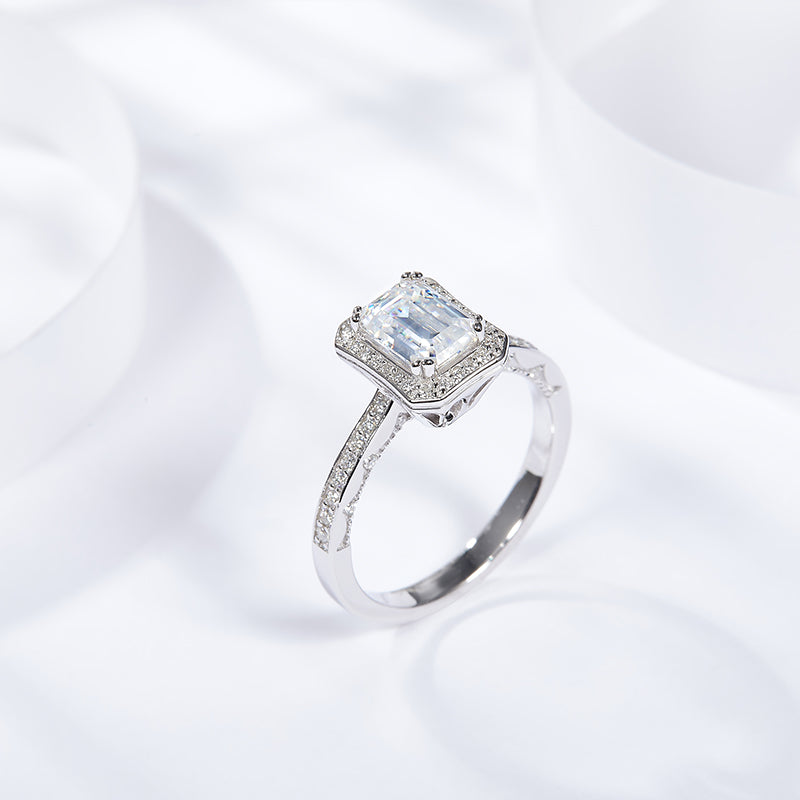 CARISSIE emerald cut moissanite halo ring, angled side view showing pavé band details and prong setting structure