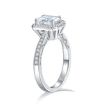 CARISSIE emerald cut moissanite halo ring, profile view revealing open gallery design and smooth polished silver shank