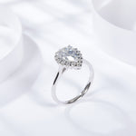 CARISSIE pear moissanite halo ring, angled perspective displaying the smooth silver-tone band profile and elegant setting height