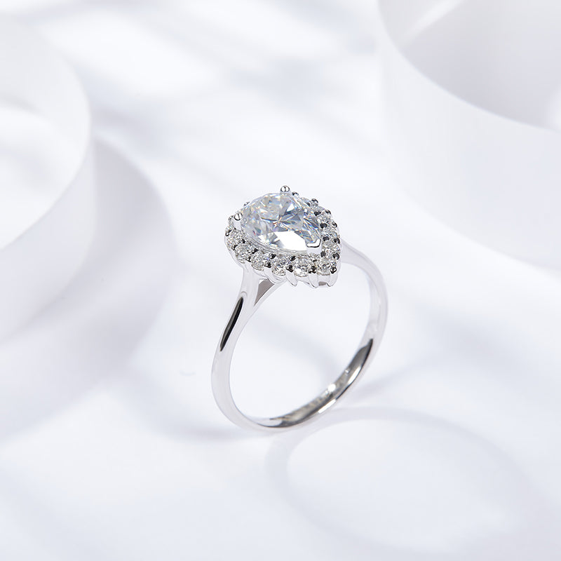 CARISSIE pear moissanite halo ring, angled perspective displaying the smooth silver-tone band profile and elegant setting height