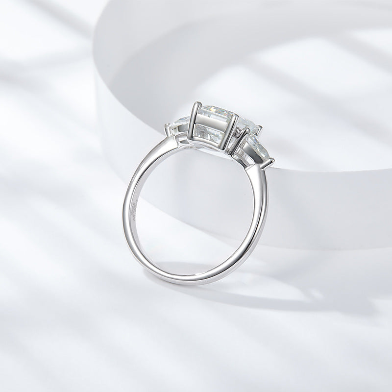 CARISSIE emerald cut solitaire ring, side profile showing the prong height and smooth polished shank design