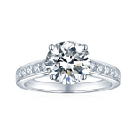 CARISSIE round moissanite solitaire ring, front view showing brilliant center stone and split shank band with channel-set accents