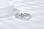 CARISSIE round moissanite solitaire ring, top-down perspective emphasizing the large center gemstone sparkle and symmetrical band design
