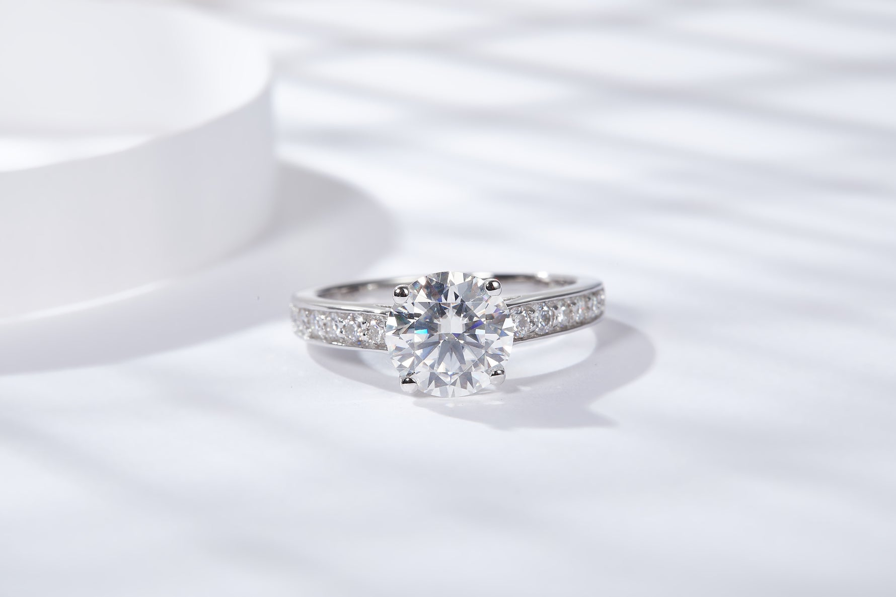 CARISSIE round moissanite solitaire ring, top-down perspective emphasizing the large center gemstone sparkle and symmetrical band design