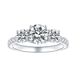 CARISSIE round moissanite solitaire ring, front view showing three-stone design with pavé band details