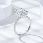 CARISSIE radiant solitaire engagement ring, angled view highlighting the pavé band and four prong setting