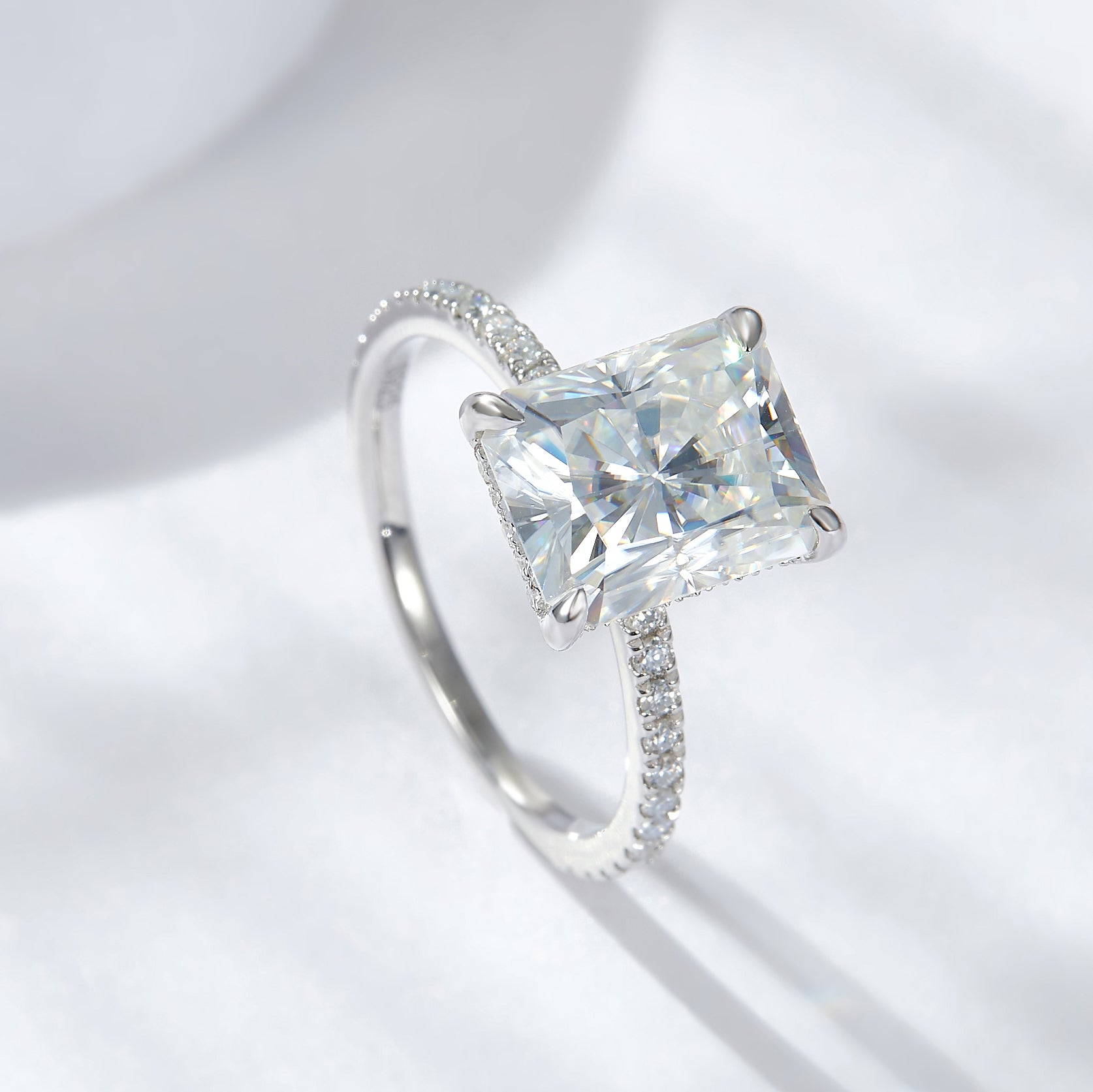 CARISSIE radiant solitaire engagement ring, high angle shot emphasizing the sparkle of the moissanite