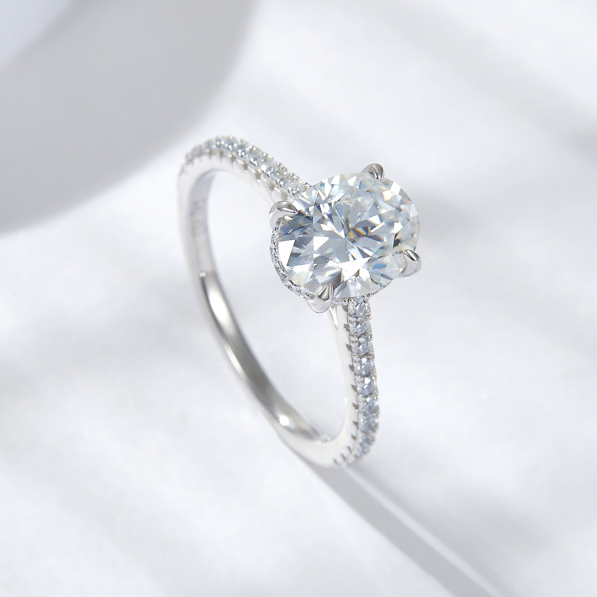 CARISSIE oval moissanite solitaire ring, angled top-down view highlighting brilliant facets of the gemstone and delicate prongs