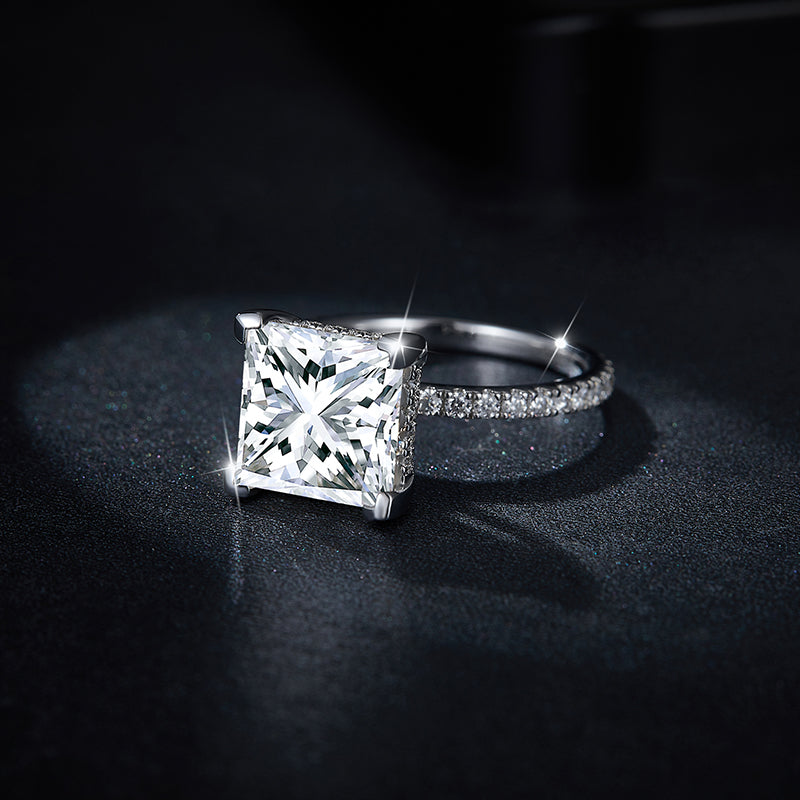 CARISSIE princess solitaire engagement ring, low-angle close-up capturing brilliant facets and silver-tone metal finish