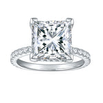 CARISSIE princess solitaire engagement ring, direct front view displaying four prongs and pavé accent stones
