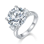 CARISSIE round moissanite solitaire ring, angled view showing large center stone and split shank with pavé accents
