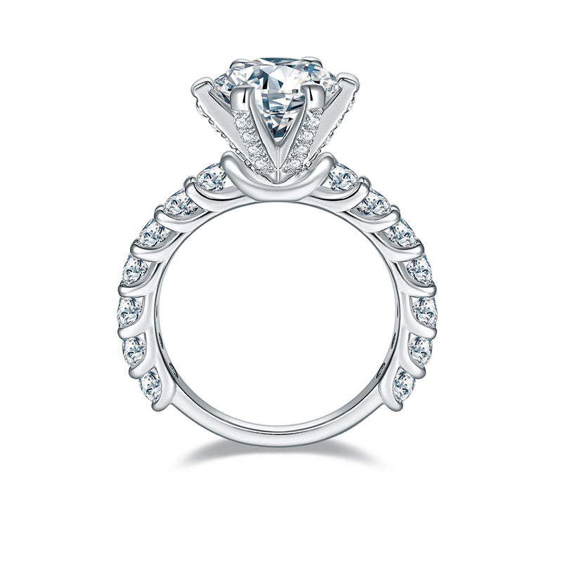 CARISSIE round moissanite engagement ring, side profile revealing twisted band with bezel-set accent stones and pavé gallery