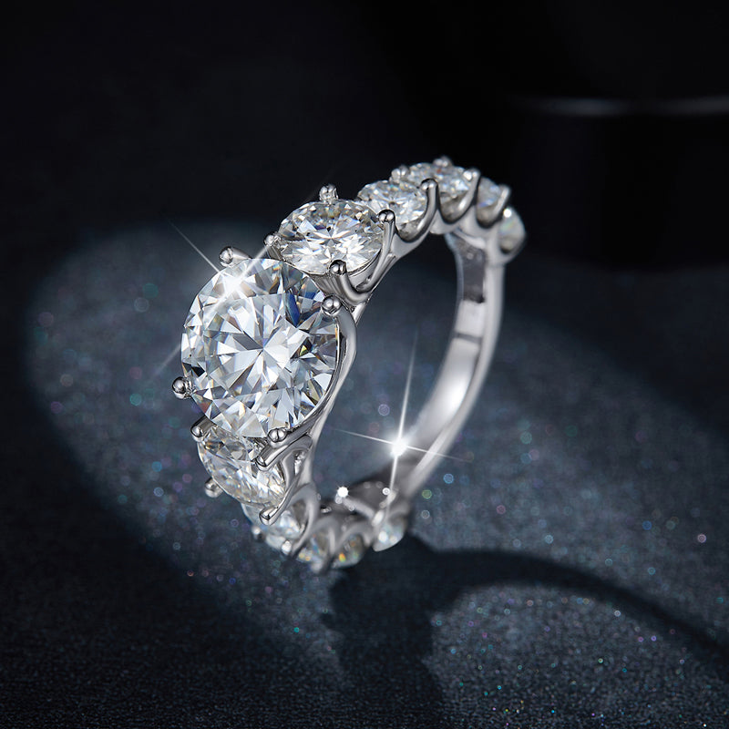 CARISSIE round moissanite solitaire ring, close-up shot on dark glittery background highlighting intense sparkle and prong details