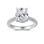 CARISSIE oval moissanite solitaire ring, front view displaying the four-prong setting and symmetrical diamond-encrusted band