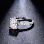 CARISSIE oval moissanite solitaire ring, dramatic side angle capturing fire in the stone and S925 hallmark on the inner band