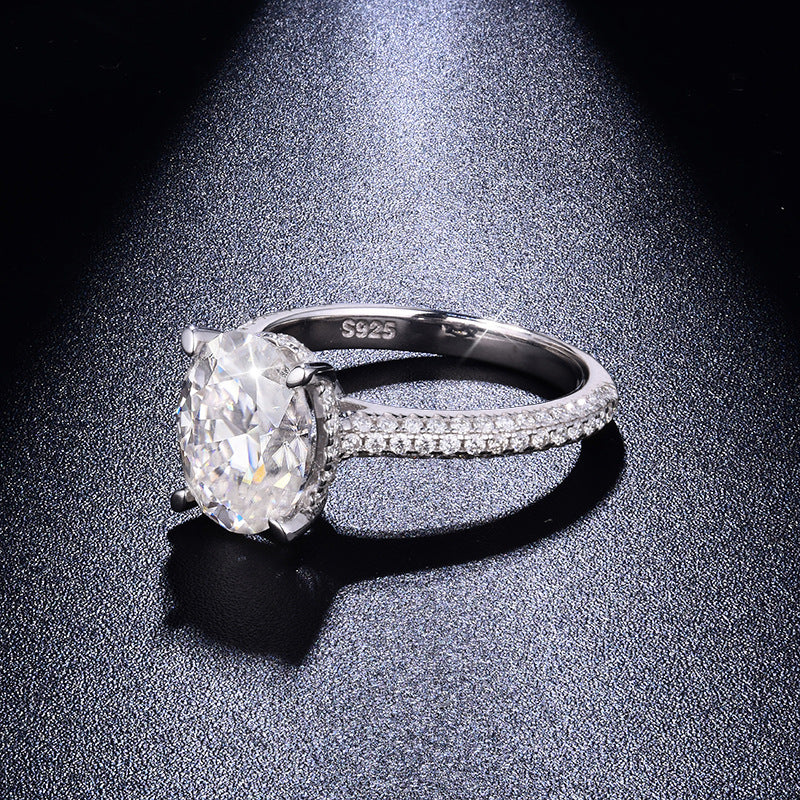 CARISSIE oval moissanite solitaire ring, dramatic side angle capturing fire in the stone and S925 hallmark on the inner band