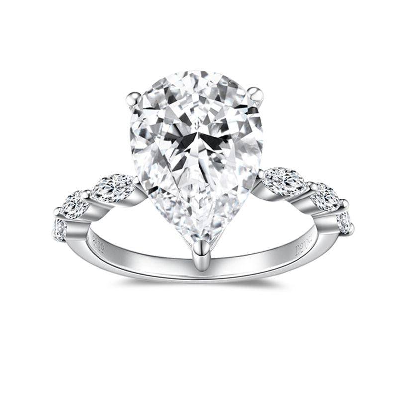 CARISSIE pear moissanite solitaire ring, front view showcasing the large center stone in a four-prong setting