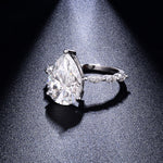 CARISSIE pear moissanite solitaire ring, side profile displaying the height of the prongs and curve of the white gold band