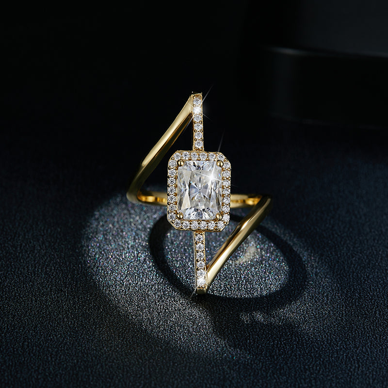 CARISSIE radiant solitaire engagement ring, angled shot on dark textured background highlighting stone sparkle and gold finish