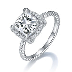 CARISSIE cushion solitaire engagement ring, angled view showing twisted rope shank and micro-pave halo
