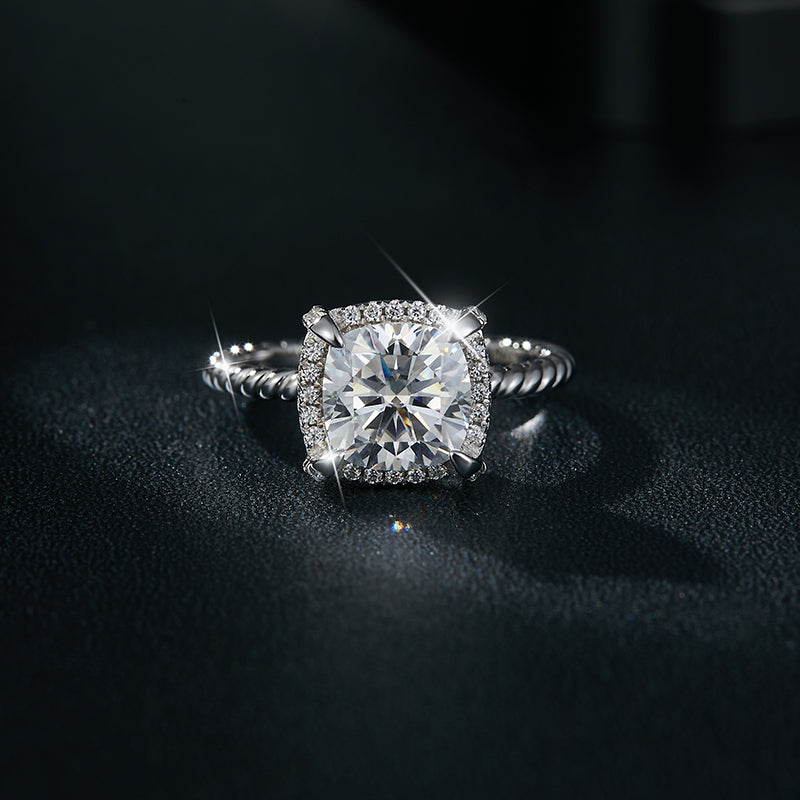 CARISSIE cushion solitaire engagement ring, close-up on dark background emphasizing brilliant sparkle