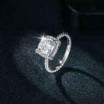 CARISSIE cushion solitaire engagement ring, diagonal angle showcasing fire dispersion in silver-tone metal