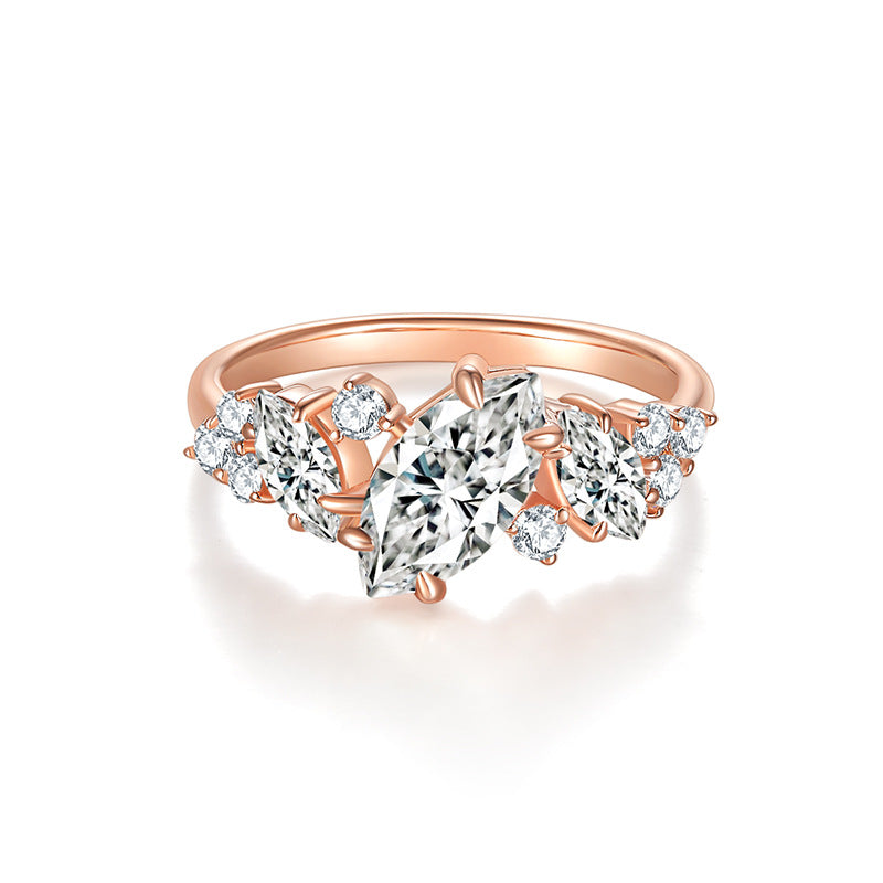 CARISSIE marquise moissanite engagement ring in rose gold, front view featuring the central 5x10mm stone flanked by smaller gems