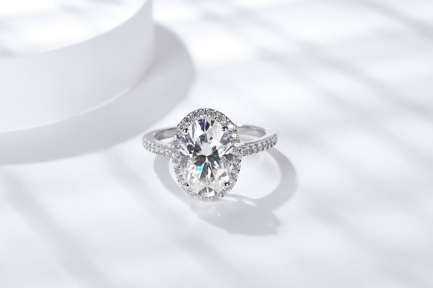 CARISSIE oval moissanite engagement ring, straight-on front view displaying the full shape of the center stone and surrounding halo