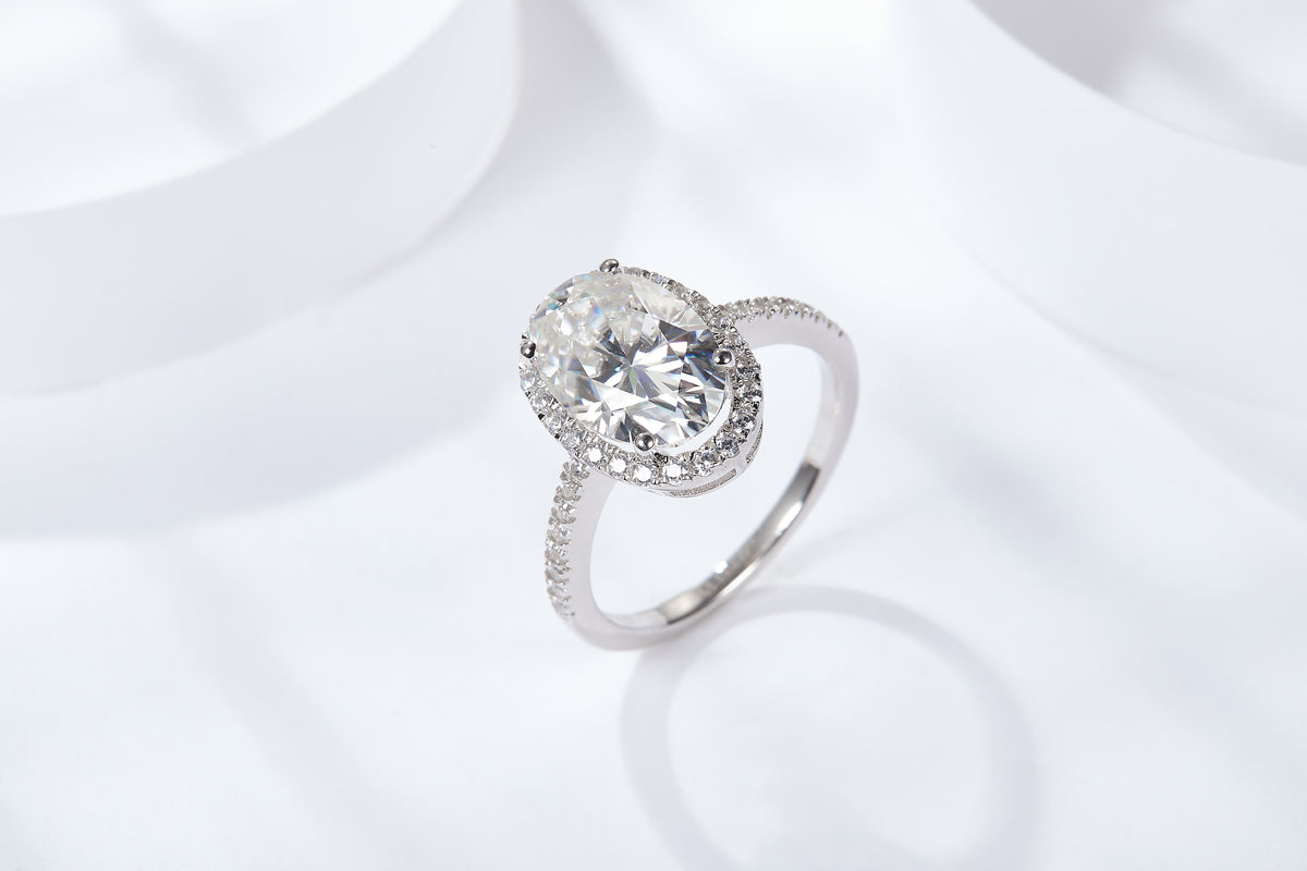 CARISSIE oval moissanite halo ring, three-quarter top angle highlighting stone brilliance against a bright white background