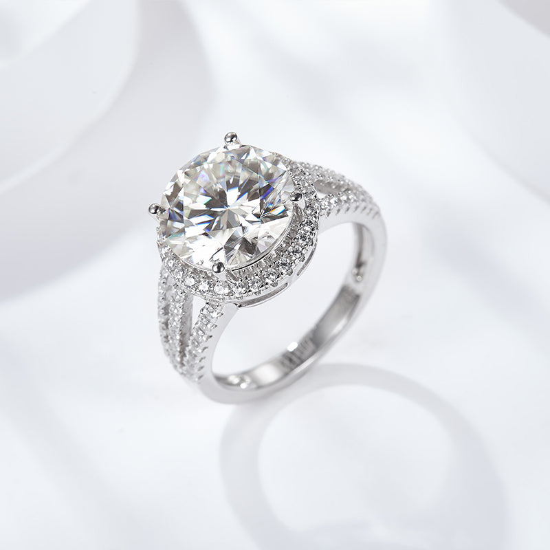 CARISSIE round moissanite pavé ring, lifestyle shot on white surface showing sparkle and prong setting details