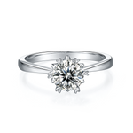 CARISSIE round moissanite solitaire ring, front view displaying the starburst prongs surrounding the brilliant center stone