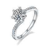 CARISSIE round moissanite solitaire ring, angled view showing split shank band with pavé diamonds and high four-prong setting