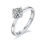 CARISSIE round moissanite solitaire ring, angled view highlighting heart-shaped prongs and polished silver-tone band