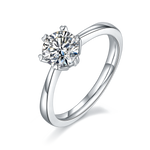 CARISSIE round moissanite solitaire ring, angled view highlighting the six-prong setting and polished silver-tone band