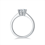 CARISSIE round moissanite solitaire ring, side profile revealing the elevated prongs and sleek design of the silver band